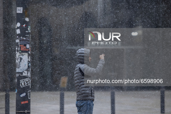 A snow storm hits New Islington Marina in Manchester city centre, UK, just days after the temperature reached 21C, on 6th April 2021. 