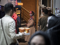 An Iranian woman living in the holy city of Qom, 145Km (90 miles) south of Tehran, looks on as she stands out of a fast-food restaurant at n...