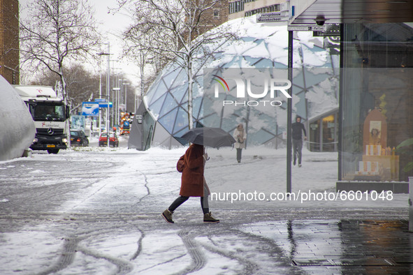 A woman as seen holding an umbrella and walking on the snow. The third day of the unusual April snowfall in The Netherlands, the country wak...