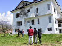 Kashmiri people access the damaged residential house where the militants were believed to be trapped during cordon in Gulab Bagh area of Sri...