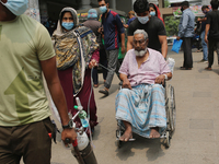 A Covid-19 patient is being taken to Dhaka Medical College Hospital with his family members for treatment in Dhaka, Bangladesh on April 08,...