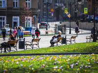 People enjoy sunny spring weather during the coronavirus pandemic at the Podgorski Square in Krakow, Poland on April 1sr, 2021. (