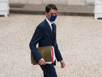 Government spokesman Gabriel Attal leaves the Elysée Palace after the Council of Ministers to go to the room where the press conference, lar...