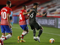 Bruno Fernandes, of Manchester United and Maxime Gonalons, of Granada CF during the UEFA Europa League Quarter Final leg one match between G...