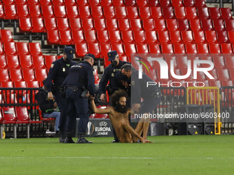 A naked man known as Olmo Garcia jumps into the field during the UEFA Europa League Quarter Final leg one match between Granada CF and Manch...