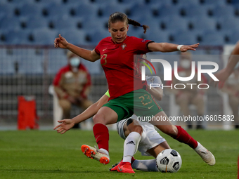 Telma Encarnacao of Portugal (top) vies with Telma Encarnacao of Russia during the UEFA Women's EURO 2022 play-off first leg match between P...
