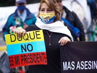 A woman holds a sign that says ''Duque is not my president'', at the protest on the international day of victims in Bogota, Colombia, on Apr...