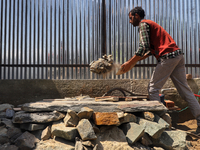 A Labour works at a construction site of a house in Sopore, District Baramulla, Jammu and Kashmir, India on 10 April 2021. Authorities in Ka...
