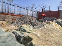 A Labour works at a construction site of a house in Sopore, District Baramulla, Jammu and Kashmir, India on 10 April 2021. Authorities in Ka...