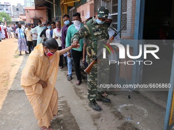 An elderly voter is assisted by A paramilitary personnel after casting her vote at a polling station during Phase 4 of West Bengal's legisla...