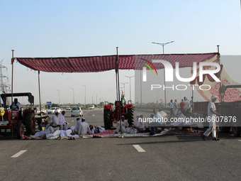 Farmers sit in a tent during a 24-hour blockade of KMP Expressway (Kundli–Manesar–Palwal) as part of their ongoing protests against the thre...