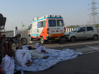 Farmers allow an ambulance to pass through during a 24-hour blockade of KMP Expressway (Kundli–Manesar–Palwal) as part of their ongoing prot...
