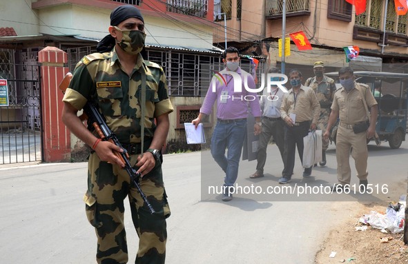 Indian  Polling  personnel   with protection of central force  going  to collect the vote of elderly voters from  their home  in North 24 Pa...