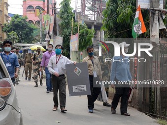 Indian  Polling  personnel   with protection of central force  going  to collect the vote of elderly voters from  their home  in North 24 Pa...
