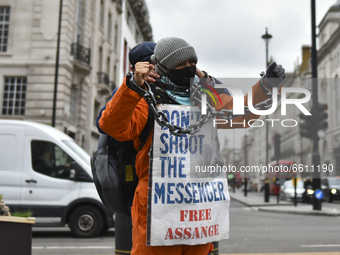 Demonstrators protest against the extradition of Wki Leaks founder Julian Assange in Piccadilly Circus, London on Saturday 10th April 2021...
