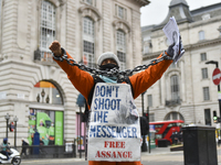 Demonstrators protest against the extradition of Wki Leaks founder Julian Assange in Piccadilly Circus, London on Saturday 10th April 2021...