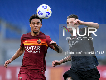 Bryan Reynolds of AS Roma and Mitchell Dijks of Bologna FC compete for the ball during the Serie A match between AS Roma and Bologna FC at S...