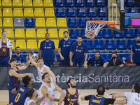 Basketball players watching the ball on the basket in the last minute of the Barça vs Real Madrid match of ACB league on April 11, 2021, in...