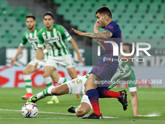 Aissa Mandi of Real Betis Balompie in action with Angel Correa of Atletico de Madrid during the La Liga Santander match between Real Betis a...