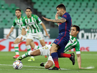 Aissa Mandi of Real Betis Balompie in action with Angel Correa of Atletico de Madrid during the La Liga Santander match between Real Betis a...
