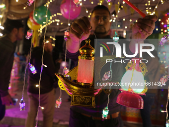 A Palestinian shopkeepers sells lanterns ahead of the fasting month of Ramadan, in Gaza City, on April 11, 2021, amid the coronavirus pandem...