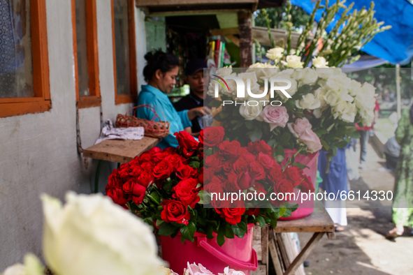 A woman sells flowers waits for a customers at Cibarunai Tomb on 12, April, 2021 in Bandung, Indonesia. Before the month of Ramadan begins,...