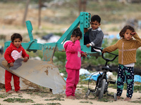 Palestinian children play next to their home near the border with Israel, amid the coronavirus disease (COVID-19) outbreak, in the northern...