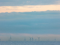Off-shore wind park of windmills generating green renewable electric energy 20 kilometers away from the Dutch coast between the Netherlands...