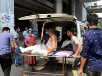 A Covid-19 patient is being taken to Dhaka Medical College Hospital with his family members for treatment in Dhaka, Bangladesh, on April 12,...