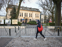 A woman wearing a face mask walks past the Constitutional Tribunal in Warsaw, Poland on April 13, 2021. On Thursday the Constitutional Tribu...