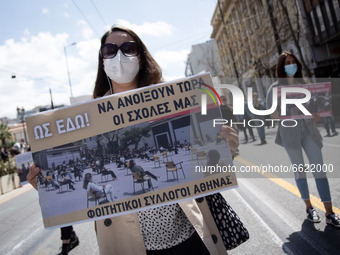 Student wearing protective face masks hold a banner during a protest against the government-promoted plan to create dedicated university pol...