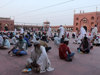 Muslims wait to break fast (iftar) during the holy month of Ramadan, amidst the spread of the coronavirus disease (Covid-19), at Jama Masjid...
