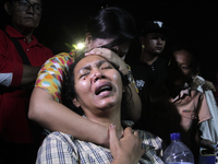 Indonesian women from one of the families of victims of the collapse of the Hercules C-130 cried hysterically when the bodies arrived at Ada...