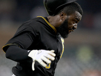Pittsburgh Pirates' Josh Harrison scores a run in the 14th inning on a double hit by Neil Walker of a baseball game against the Detroit Tige...