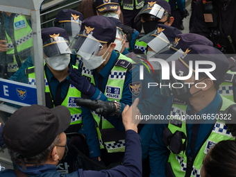 Protesters conflict with police officers during a protest against the Japanese government's decision to release radioactive water from Fukus...