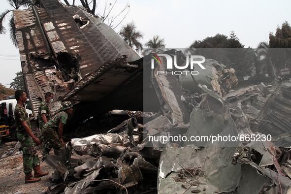 Indonesian military personnel inspect aircraft wreckage Indonesia C-130 Hercules day after the crash in Medan, North Sumatra, Indonesia on J...