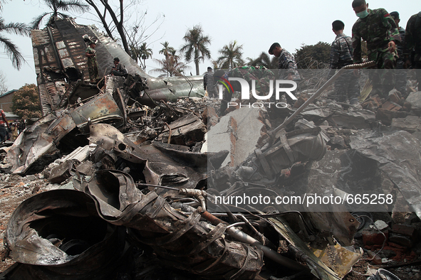 Indonesian military personnel inspect aircraft wreckage bodies Indonesian C-130 Hercules day after the crash in Medan, North Sumatra, Indone...