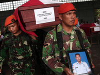 Indonesian military personnel lifting body coffin corpse military personnel, one of the victims of the collapse of the C-130 military aircra...