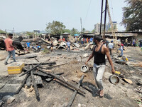 People search for their belongings in debris after a fire broke out in the Bamunimaidan area in Guwahati, India on April 25,2021. (