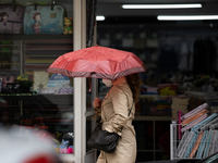 A women using umbrella to protect yourself from bad weather in Lisbon, Portugal, on April 26, 2021.
Lola Storm hits Portugal with winds and...