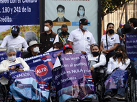 Persons take part during a protest, outside the National Palace, due were victims of fraud by the  Banco Ahorro Famsa, on April 26, 2021 in...