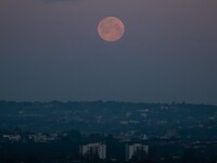 The supermoon rises above South East London, UK on April 27, 2021. A supermoon is a full moon or a new moon that nearly coincides with perig...