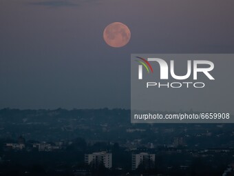 The supermoon rises above South East London, UK on April 27, 2021. A supermoon is a full moon or a new moon that nearly coincides with perig...