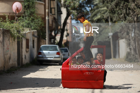 Palestinian boys play outside their home in a street in Gaza City, on April 28, 2021.  