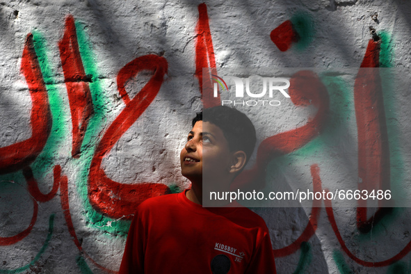 A Palestinian boy plays outside his home in Gaza City, on April 28, 2021.  