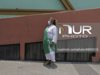 A woman dressed as St. Jude Thaddeus outside a parish of the same name located in Mexico City, Mexico, on April 28, 2021 where several peopl...