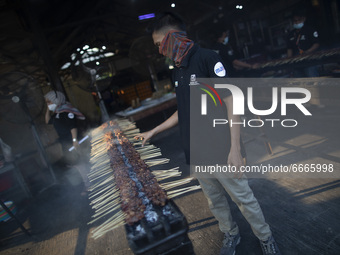A man cookings of meat of Indonesian tradtional food were prepared for breaking fasting at Purwarkarta, West Java, indonesia, on 29 April 20...