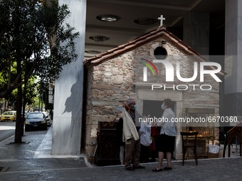 A couple after the litany outside the Agia Dynami (Holy Power) Church in Athens, Greece, on April 30, 2021.
 (