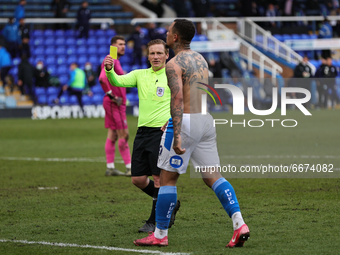  Jonson Clarke-Harris of Peterborough United is shown the yellow card by referee John Busby  during the Sky Bet League 1 match between Peter...