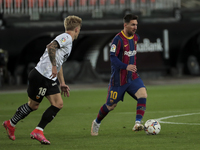 Daniel Wass of Valencia CF  (L) and FC Barcelona's forward Lionel Messi  during  spanish La Liga match between Valencia cf and Futbol Club B...